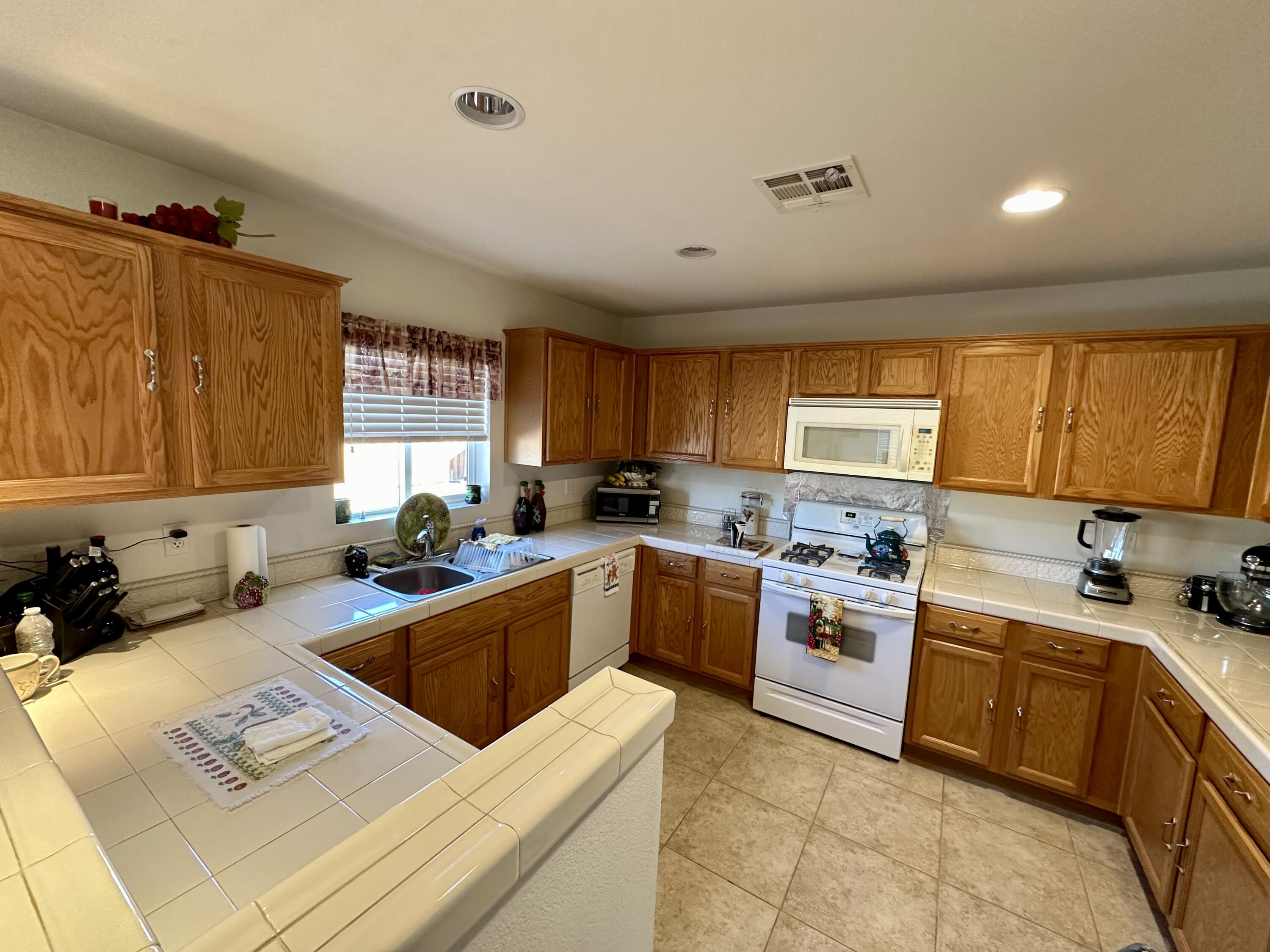 575 West Rice Street Blythe, CA 92225 - Photo 5 of 24 a kitchen with a sink a stove top oven a counter space and cabinets