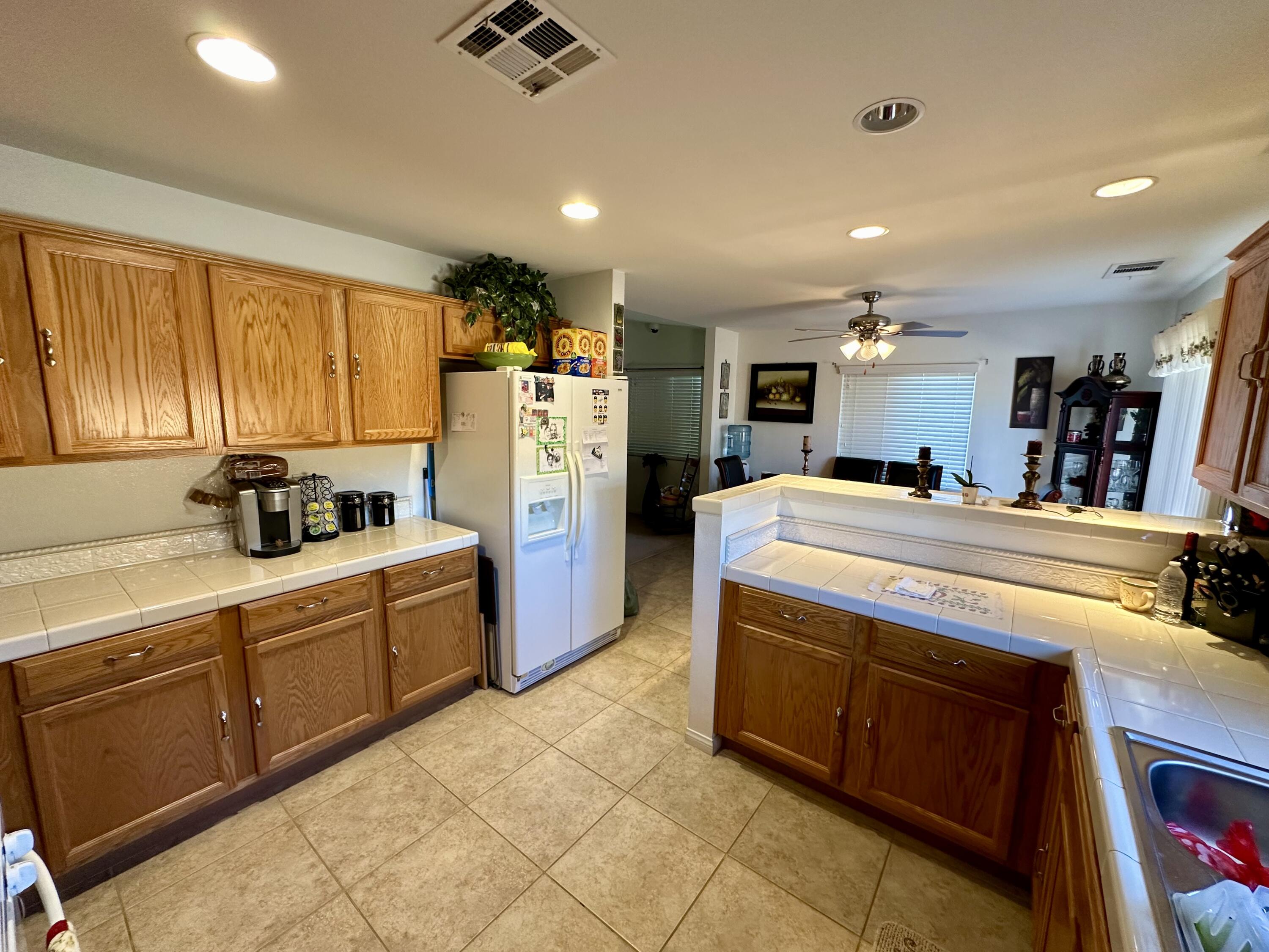 575 West Rice Street Blythe, CA 92225 - Photo 7 of 24 a kitchen with stainless steel appliances kitchen island granite countertop a refrigerator and a stove top oven