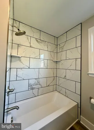 a bathroom with a bathtub and shower