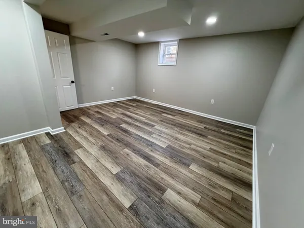 a view of room with wooden floor