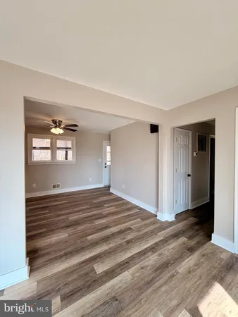 a view of a room with wooden floor and window