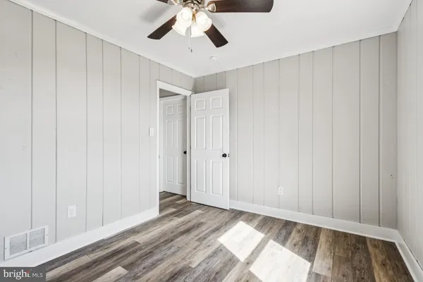 a view of an empty room and wooden floor