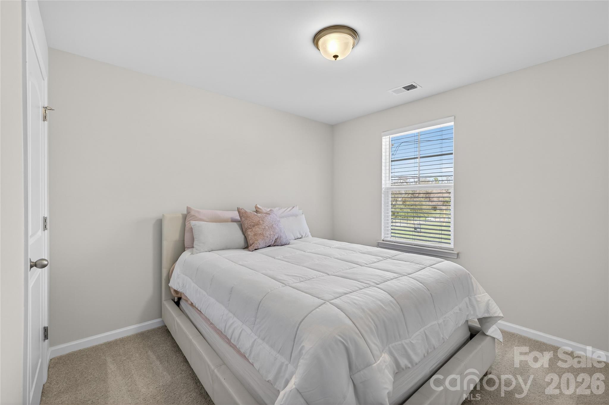 128 Pleasant Hill Street Lancaster, SC 29720 - Photo 21 of 26 a bedroom with a bed and a window