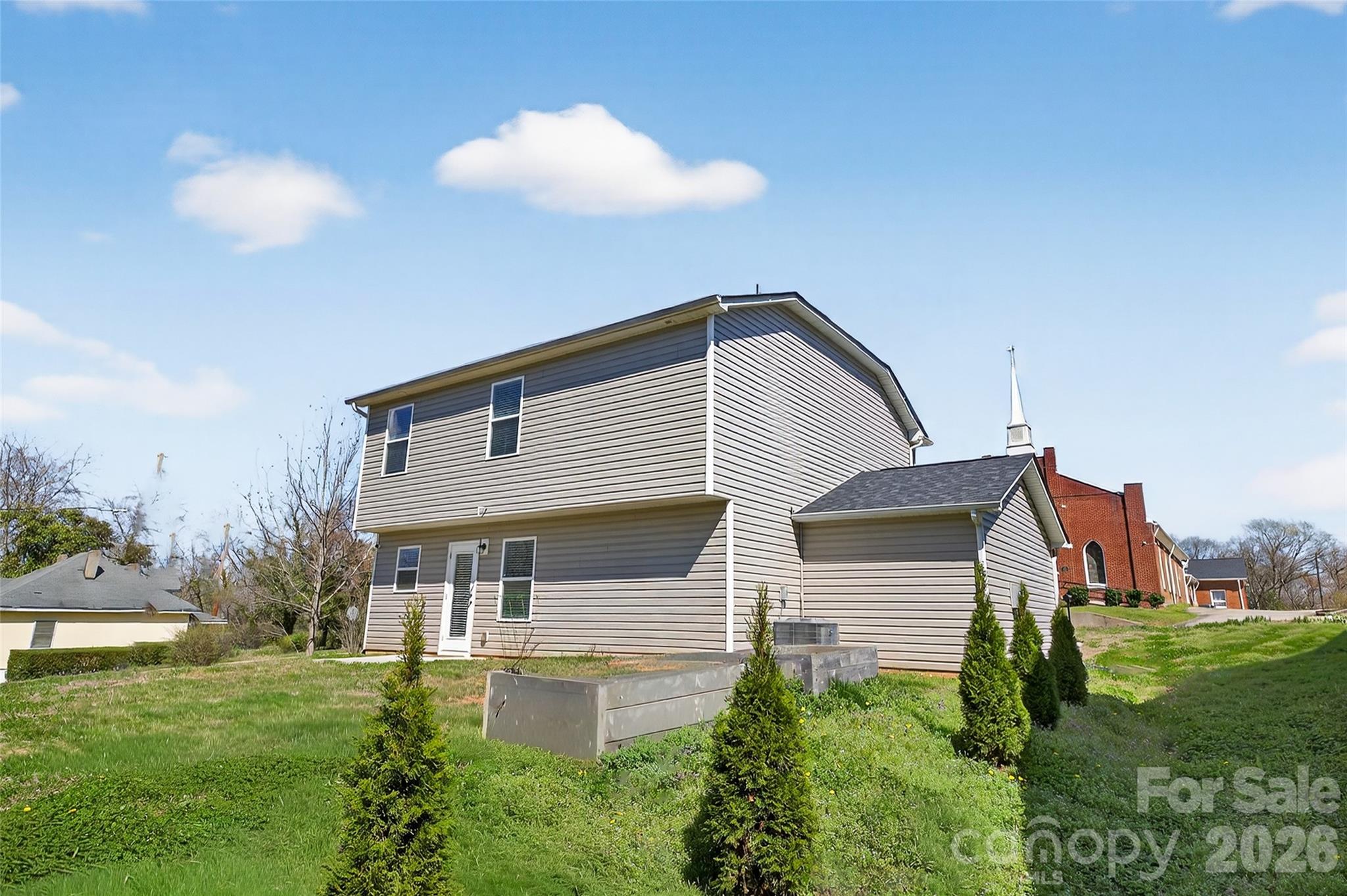 128 Pleasant Hill Street Lancaster, SC 29720 - Photo 26 of 26 a front view of house with yard and trees in the background