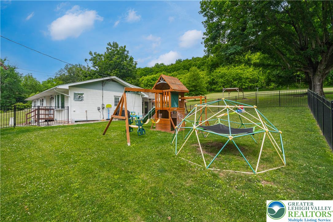 50 Kohls Road Northampton, PA 18067 - Photo 34 of 54 A spacious, verdant yard invites play with an outdoor playset and ample room for recreation.