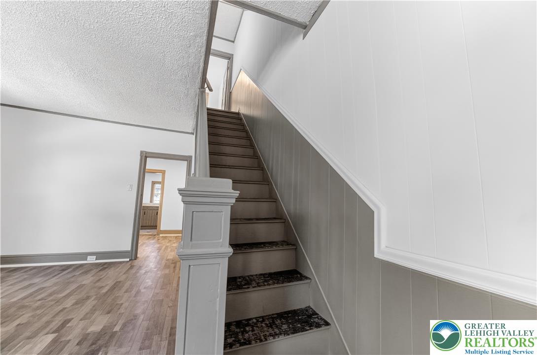 1128 Maple Street Bethlehem, PA 18018 - Photo 28 of 34 A grand staircase with textured wall panels leads to the upper level of the home.
