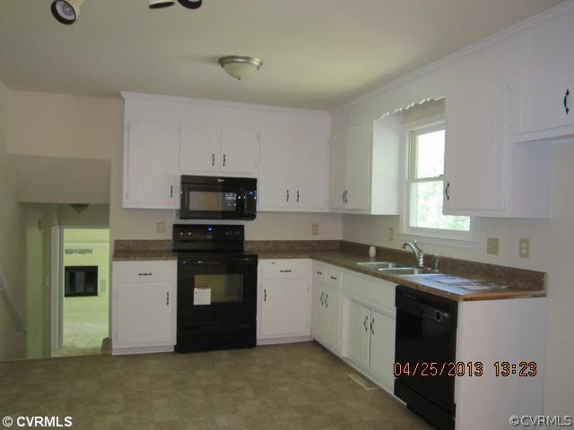 1512 Austin Road Chester, VA 23836 - Photo 5 of 14 a kitchen with a sink and a stove top oven