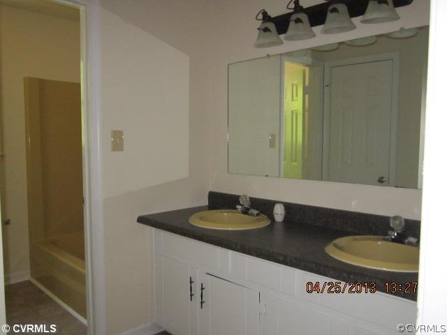 1512 Austin Road Chester, VA 23836 - Photo 10 of 14 a bathroom with a granite countertop sink and a mirror