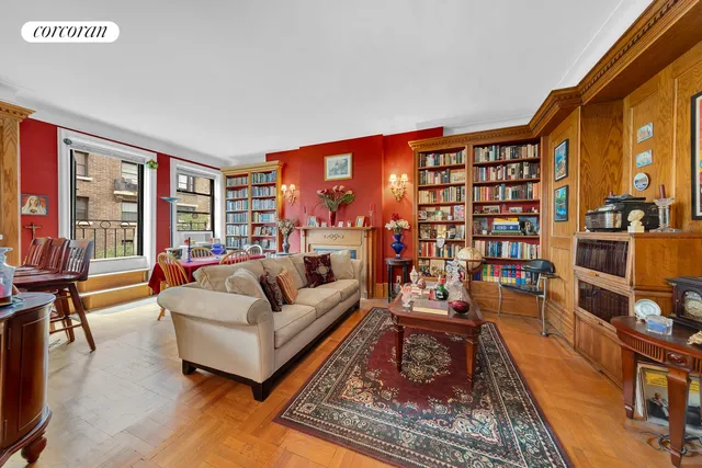 a living room with furniture a bookshelf and a large window