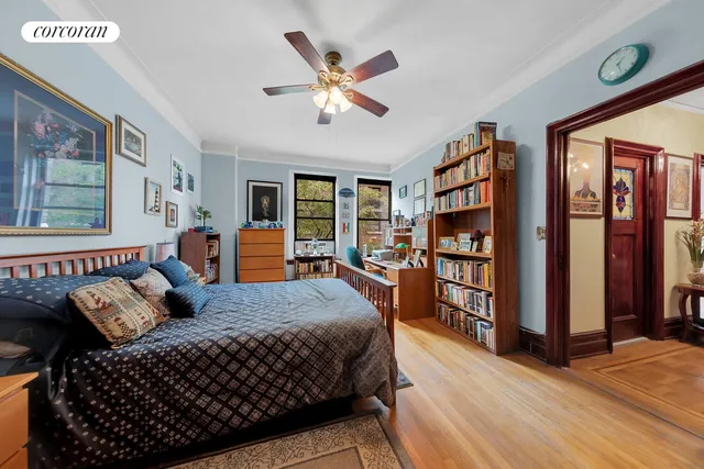 a bedroom with a large bed and a chandelier