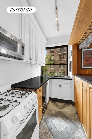 a kitchen with a stove and white cabinets