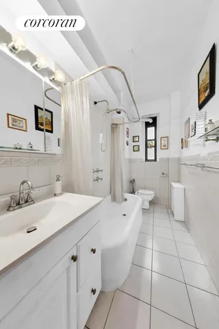 a spacious bathroom with a sink a mirror and a bathtub