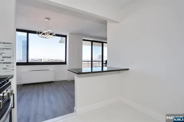 a bathroom with a sink a toilet a shower and a mirror