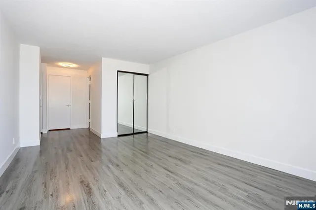 a bathroom with a granite countertop toilet sink and mirror