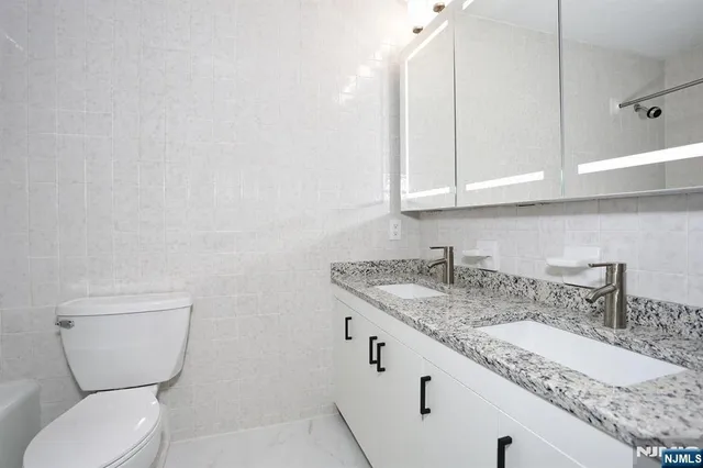 a white bath tub sitting next to a white toilet and sink