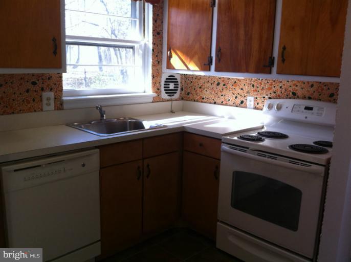 3914 Isbell Street Silver Spring, MD 20906 - Photo 13 of 17 a kitchen with a sink stove and cabinets