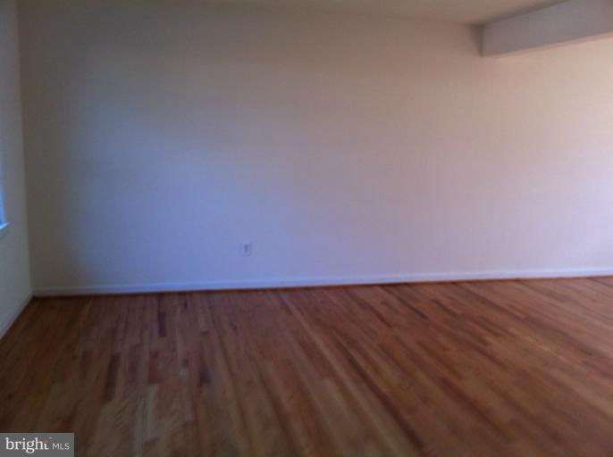 3914 Isbell Street Silver Spring, MD 20906 - Photo 15 of 17 a view of an empty room and wooden floor