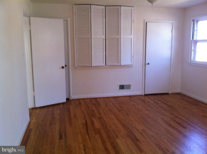3914 Isbell Street Silver Spring, MD 20906 - Photo 17 of 17 a view of an empty room with wooden floor and a window