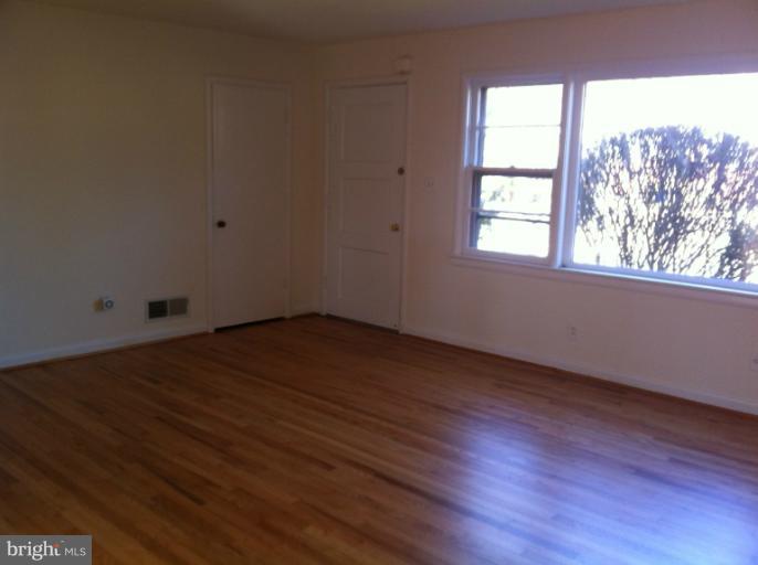 3914 Isbell Street Silver Spring, MD 20906 - Photo 4 of 17 an empty room with wooden floor and windows