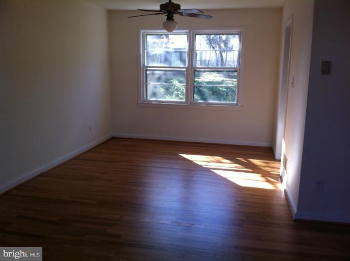 3914 Isbell Street Silver Spring, MD 20906 - Photo 5 of 17 an empty room with wooden floor and windows