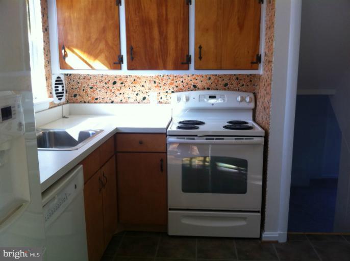 3914 Isbell Street Silver Spring, MD 20906 - Photo 7 of 17 a kitchen with a sink stove and cabinets