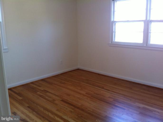 3914 Isbell Street Silver Spring, MD 20906 - Photo 10 of 17 an empty room with wooden floor and windows