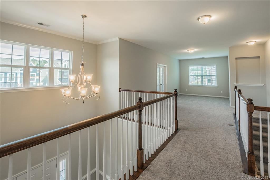 5116 Waterloo Drive, Unit 60 Tega Cay, SC 29708 - Photo 14 of 36 a view of empty room with wooden floor and fan