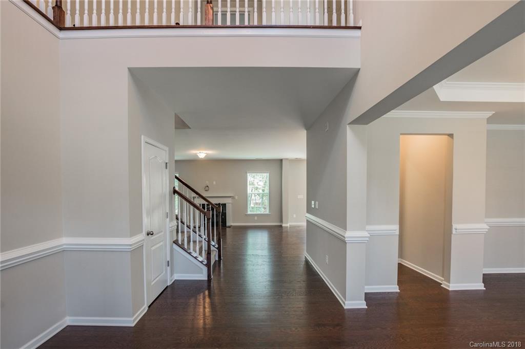 5116 Waterloo Drive, Unit 60 Tega Cay, SC 29708 - Photo 4 of 36 a hallway with wooden floor windows and stairs