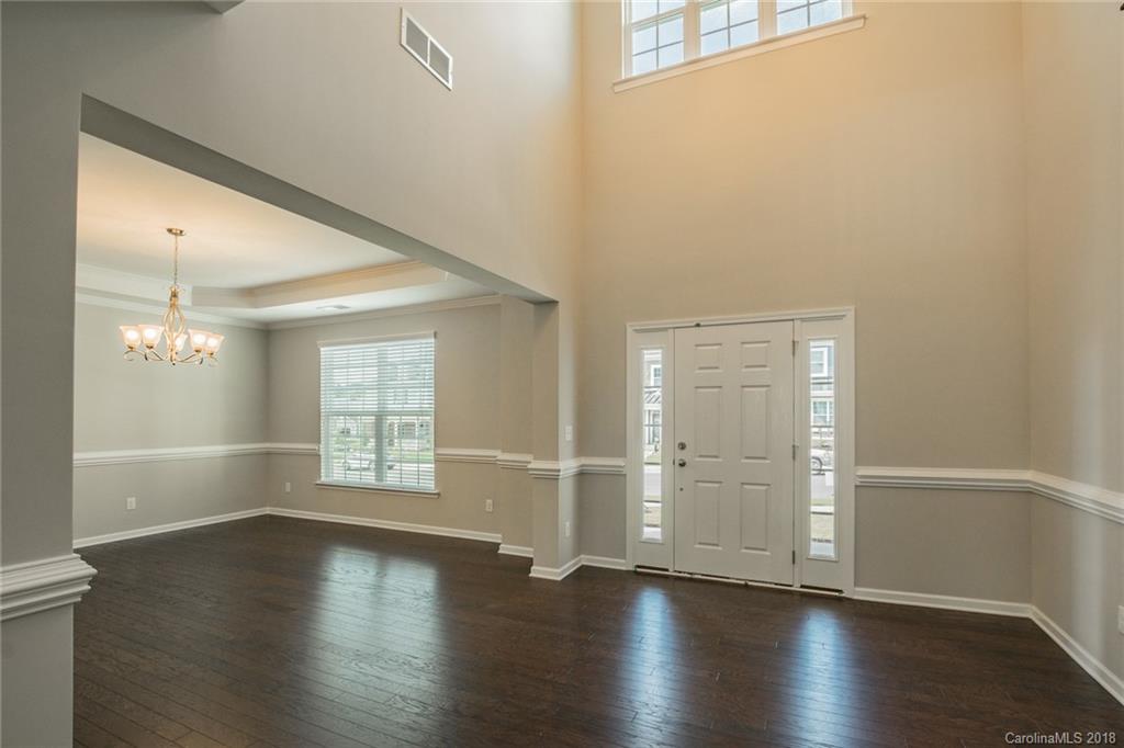 5116 Waterloo Drive, Unit 60 Tega Cay, SC 29708 - Photo 5 of 36 an empty room with wooden floor and windows