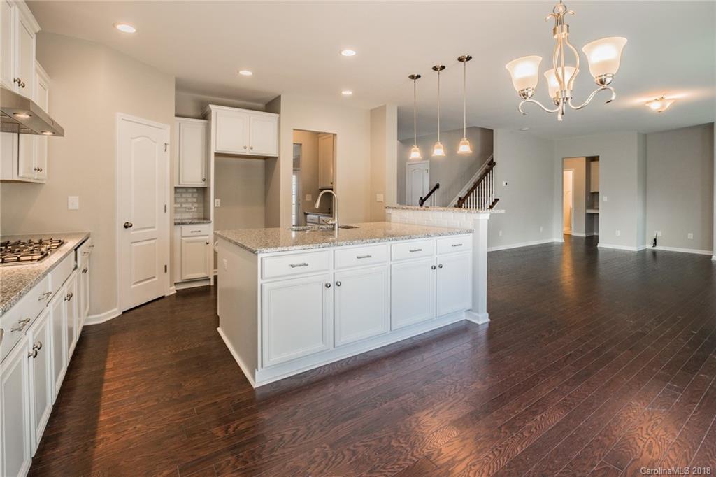 5116 Waterloo Drive, Unit 60 Tega Cay, SC 29708 - Photo 10 of 36 a large kitchen with stainless steel appliances kitchen island a large counter top and wooden floors