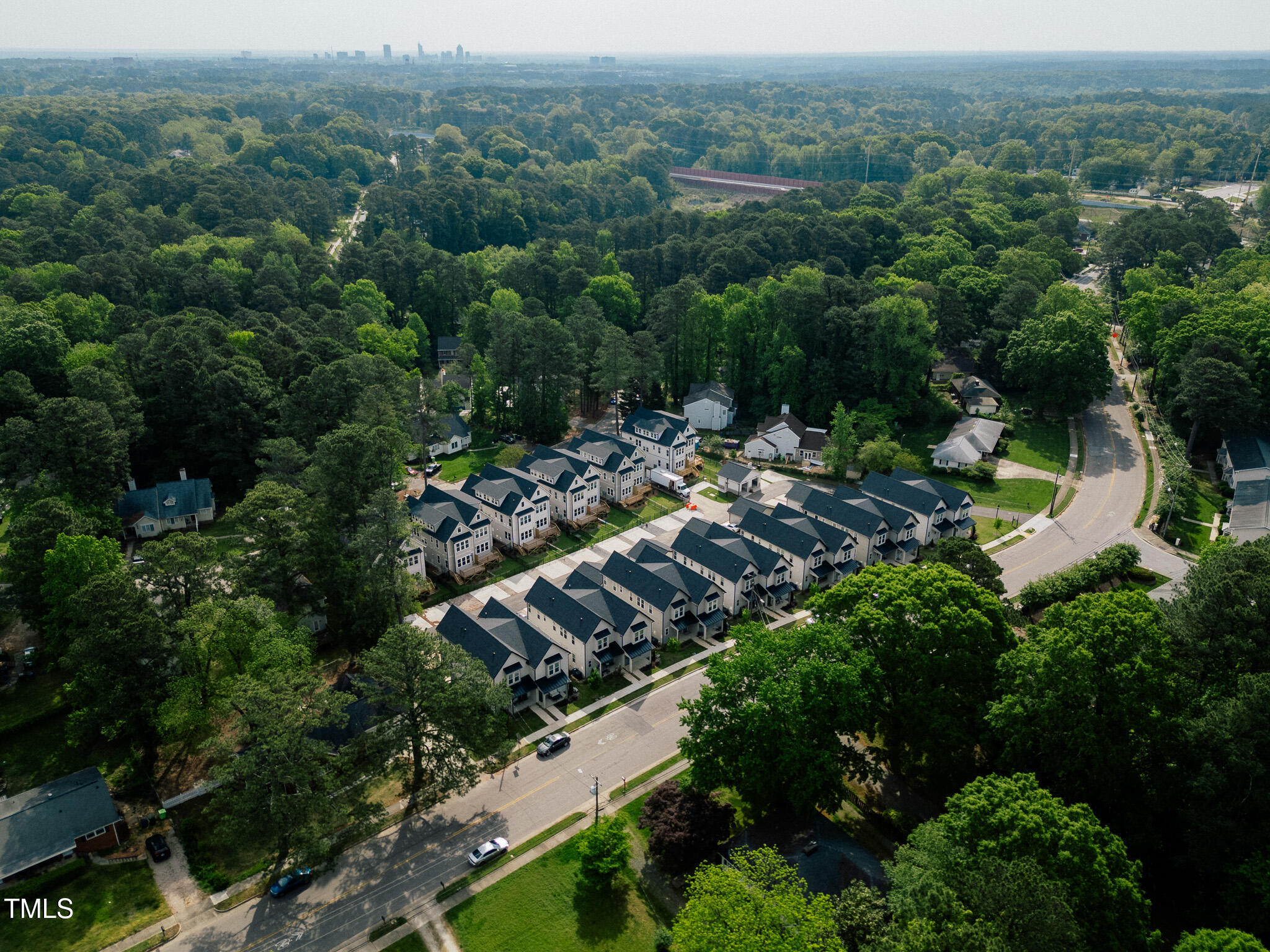 5053 Lundy Drive, Unit 102 Raleigh, NC 27606 - Photo 46 of 53 an aerial view of a town with trees