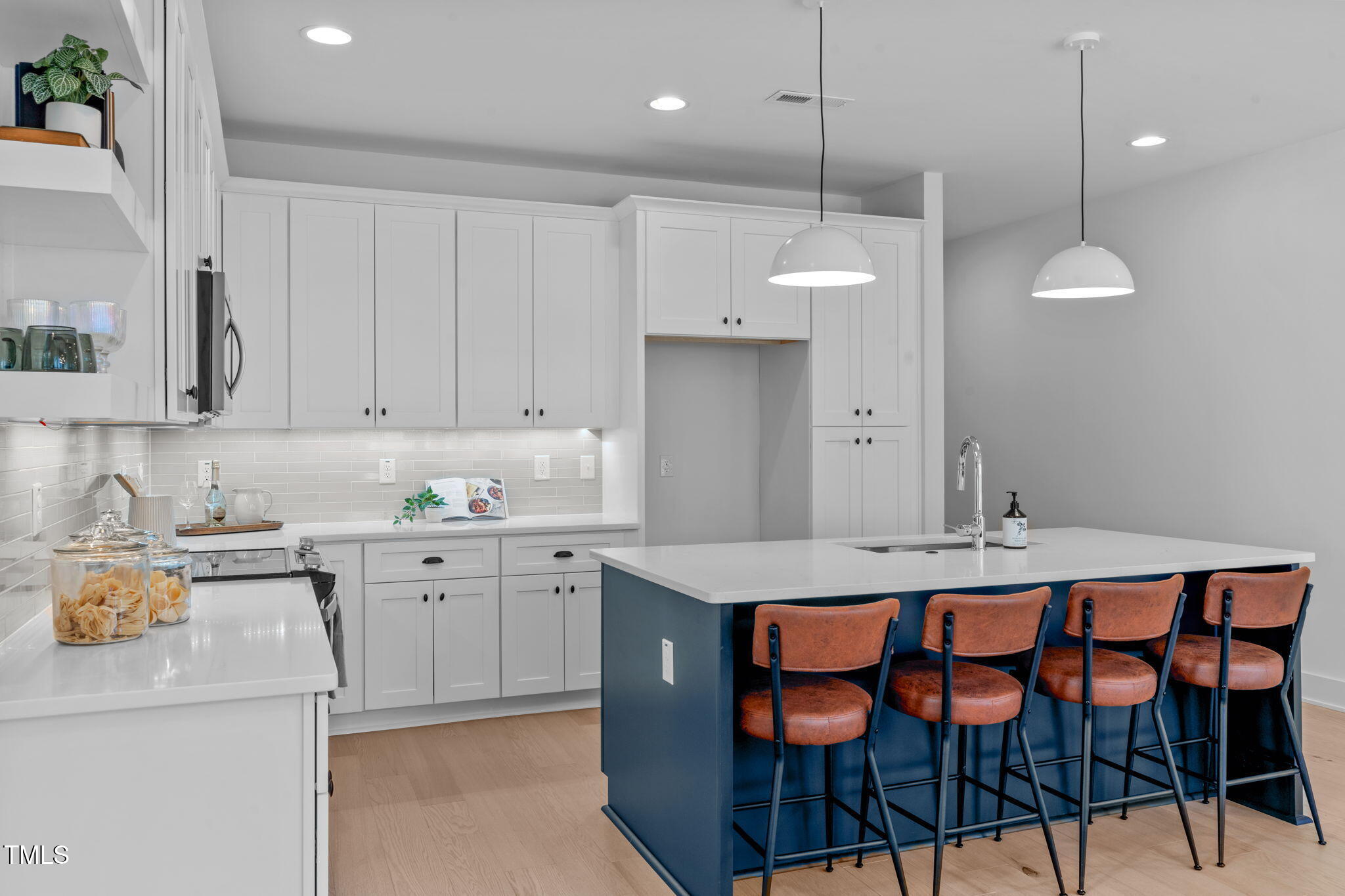 5053 Lundy Drive, Unit 102 Raleigh, NC 27606 - Photo 7 of 53 a kitchen that has a cabinets and chairs in it