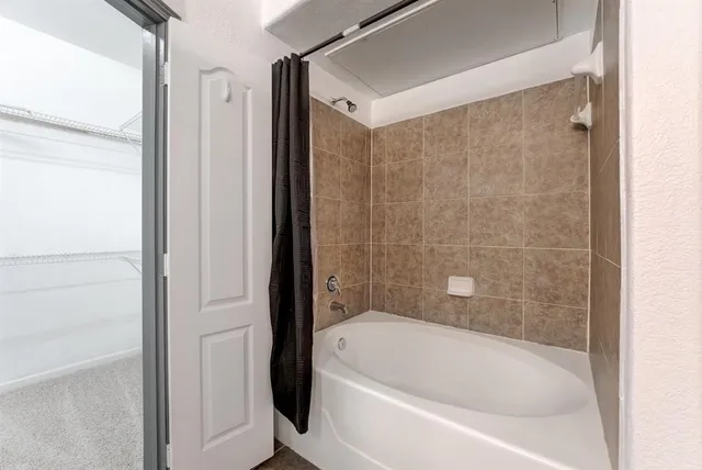 a bathroom with a bathtub and a shower
