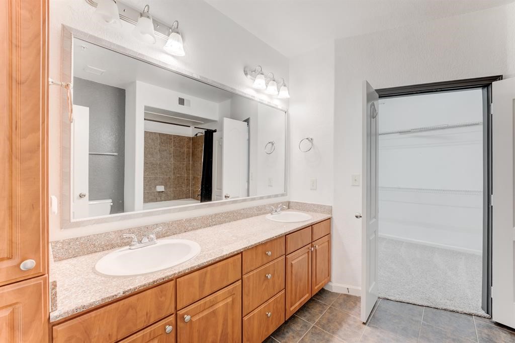 1711 Old Spanish Trail, Unit 110 Houston, TX 77054 - Photo 17 of 31 a bathroom with a sink and a mirror