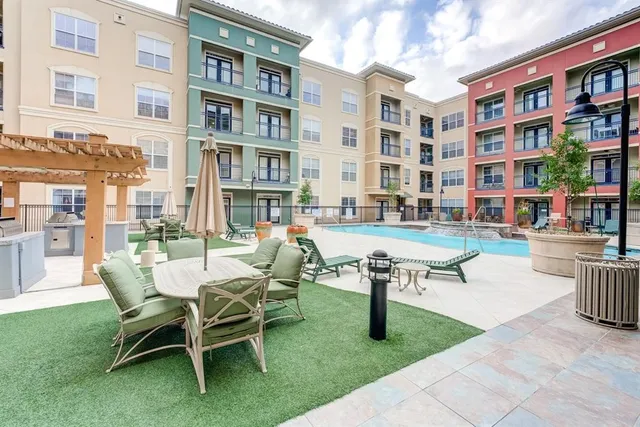 a building outdoor space with couple of chairs and a table