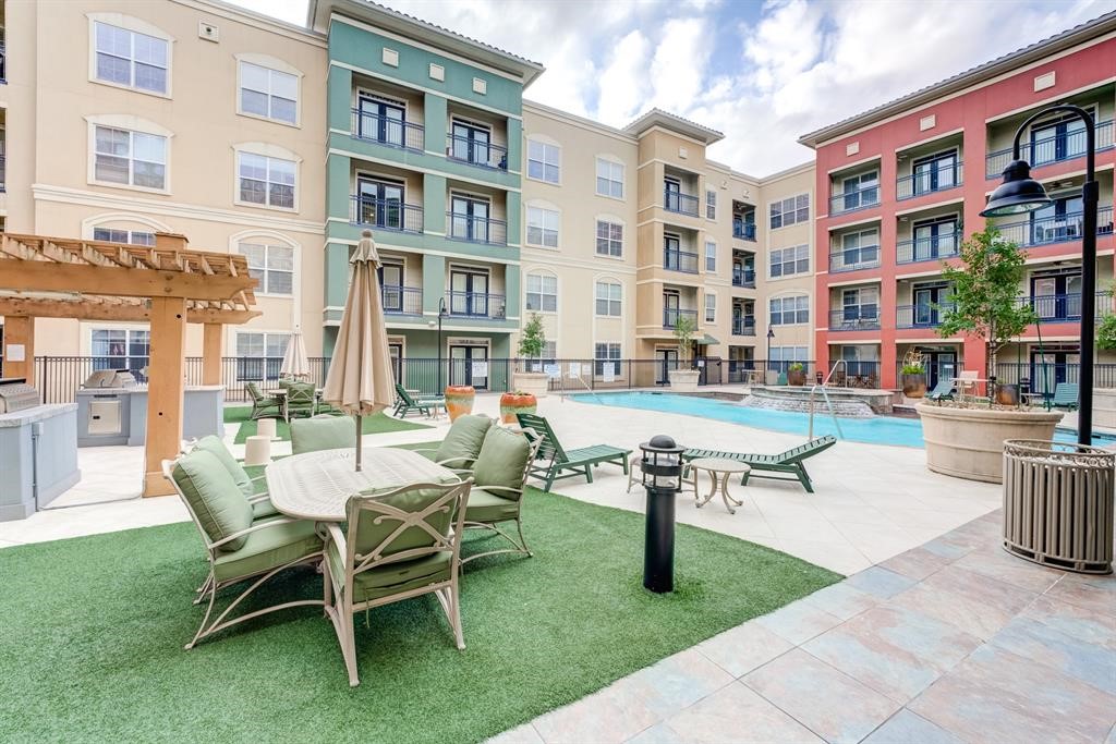 1711 Old Spanish Trail, Unit 110 Houston, TX 77054 - Photo 30 of 31 a building outdoor space with couple of chairs and a table