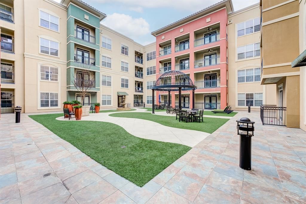 1711 Old Spanish Trail, Unit 110 Houston, TX 77054 - Photo 31 of 31 a front view of a building with a garden and plants