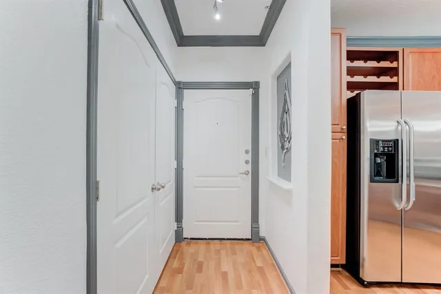 a view of a hallway with wooden floor and staircase
