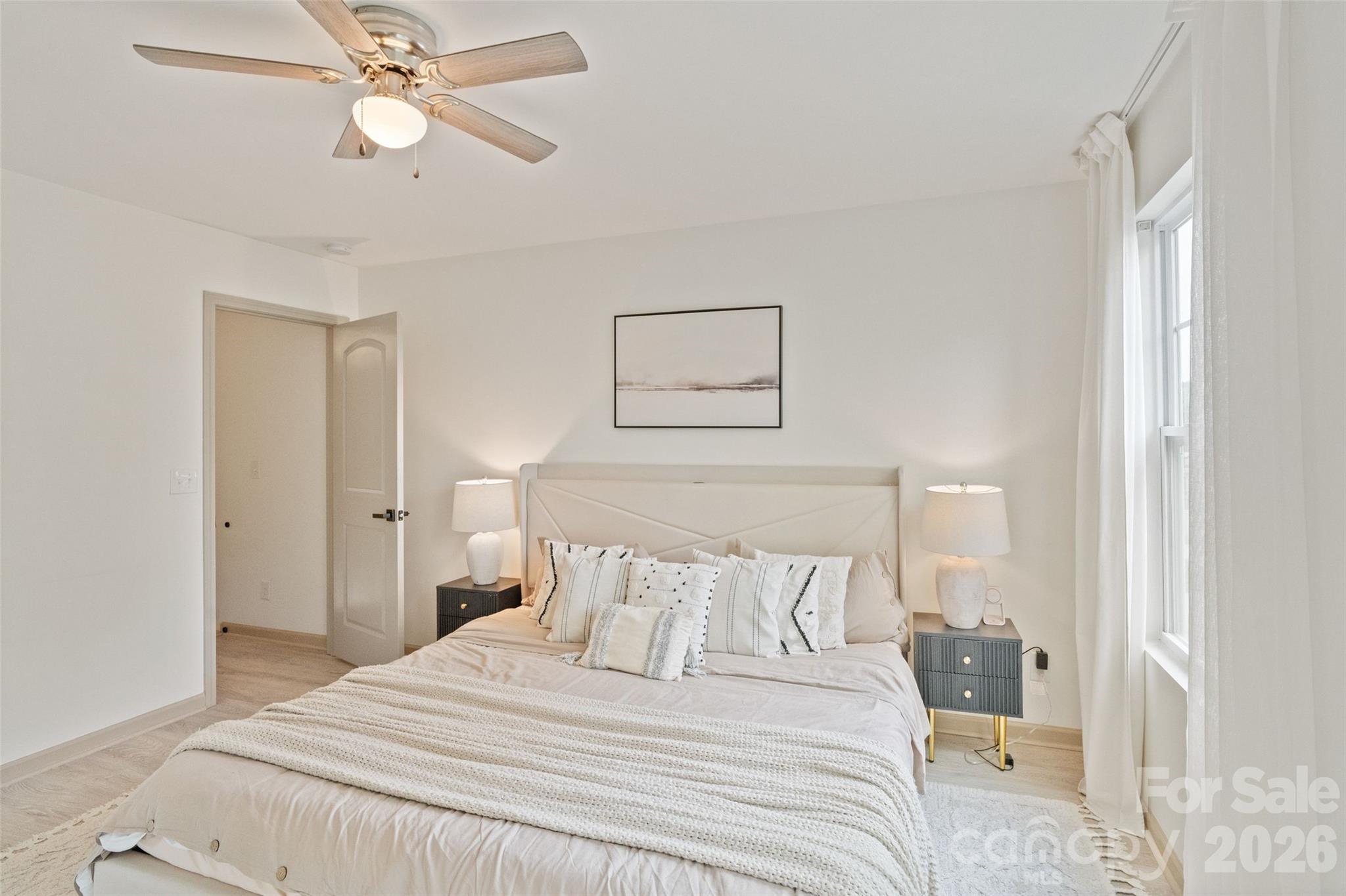 8726 Conrad Street Locust, NC 28097 - Photo 16 of 36 a bedroom with a large bed and a chandelier