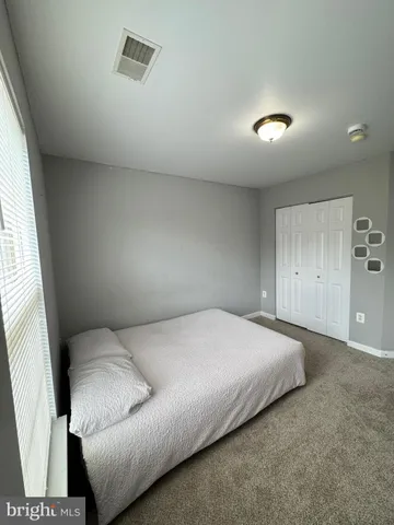 a bed sitting in a room next to a window
