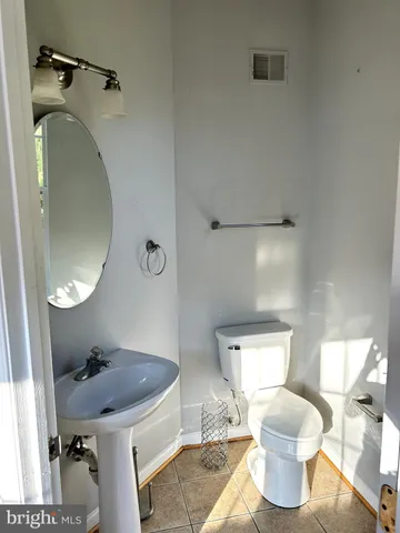 a bathroom with a sink a toilet a shower and a mirror