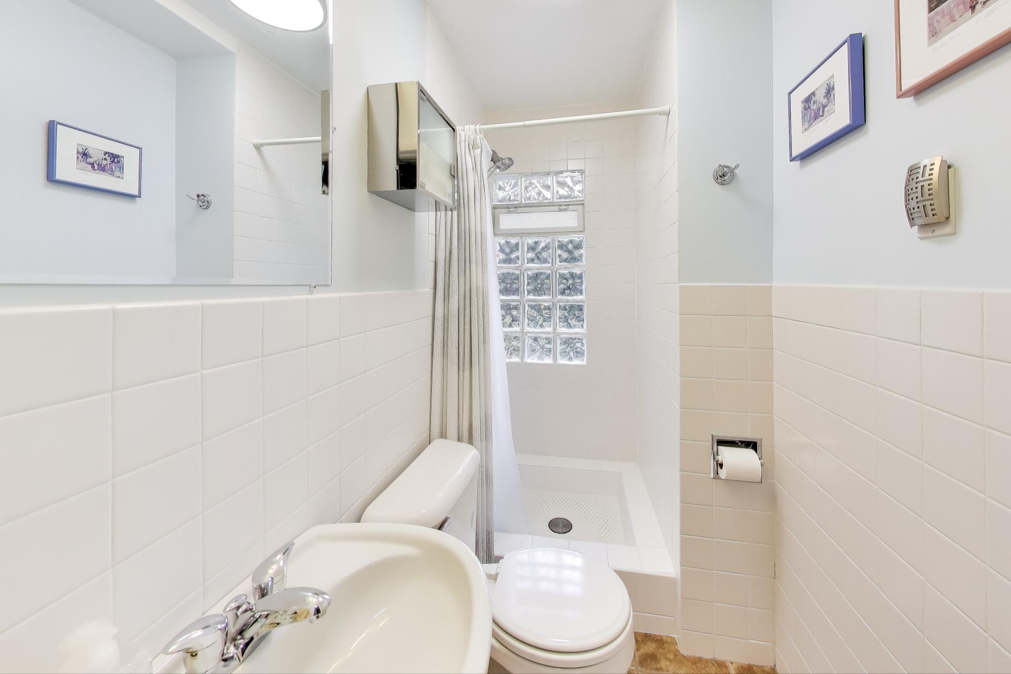 49 Aspen Road Ogden Dunes, IN 46368 - Photo 18 of 42 a white toilet sitting next to a bathroom sink