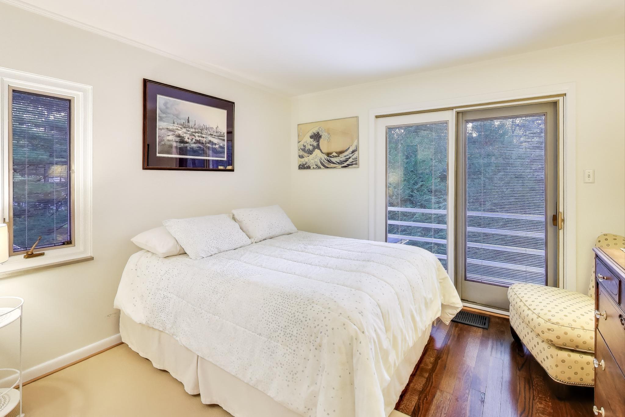 49 Aspen Road Ogden Dunes, IN 46368 - Photo 24 of 42 a bedroom with a bed wooden floor and window