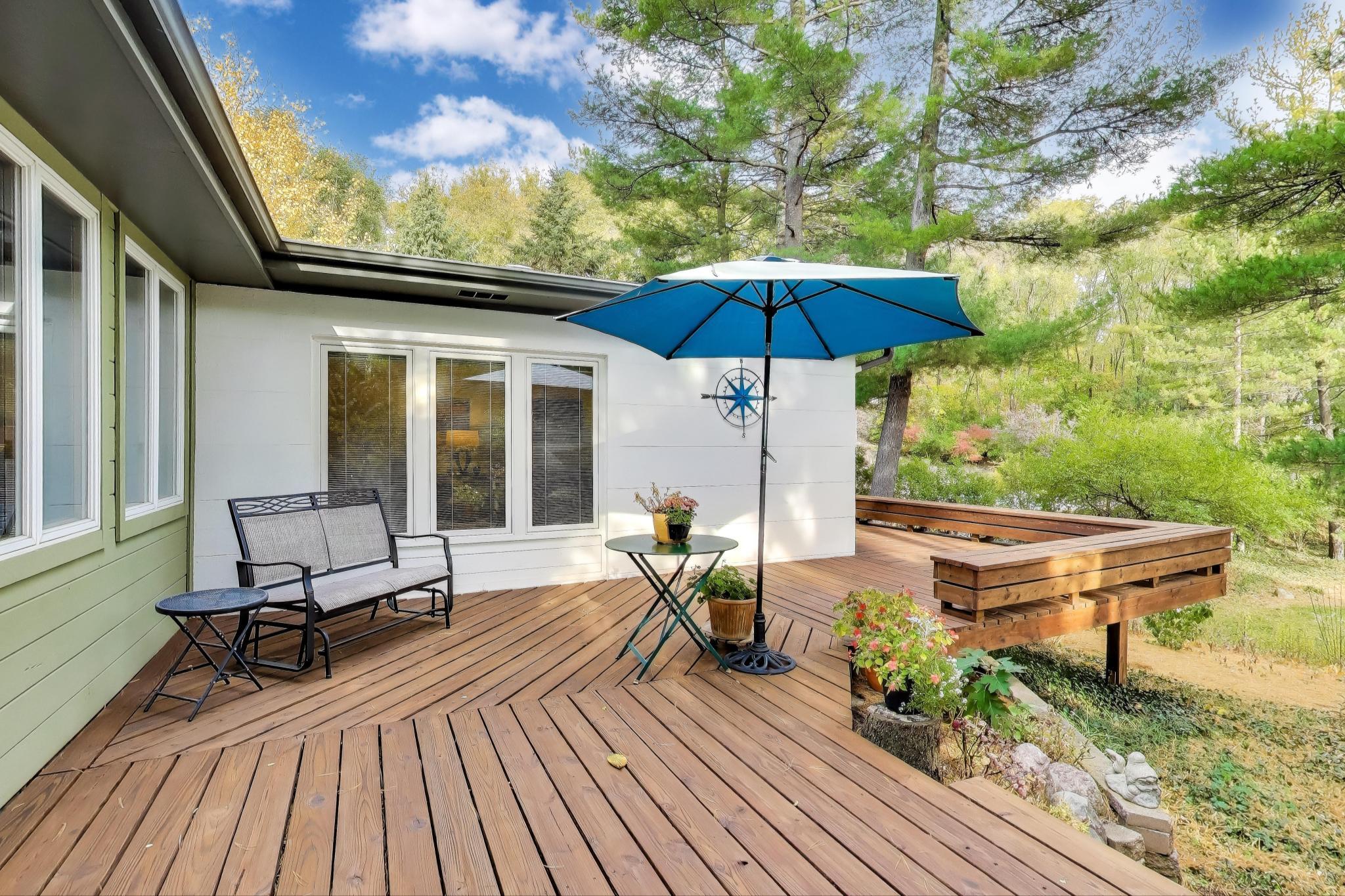 49 Aspen Road Ogden Dunes, IN 46368 - Photo 30 of 42 a view of a patio with a table chairs and a barbeque