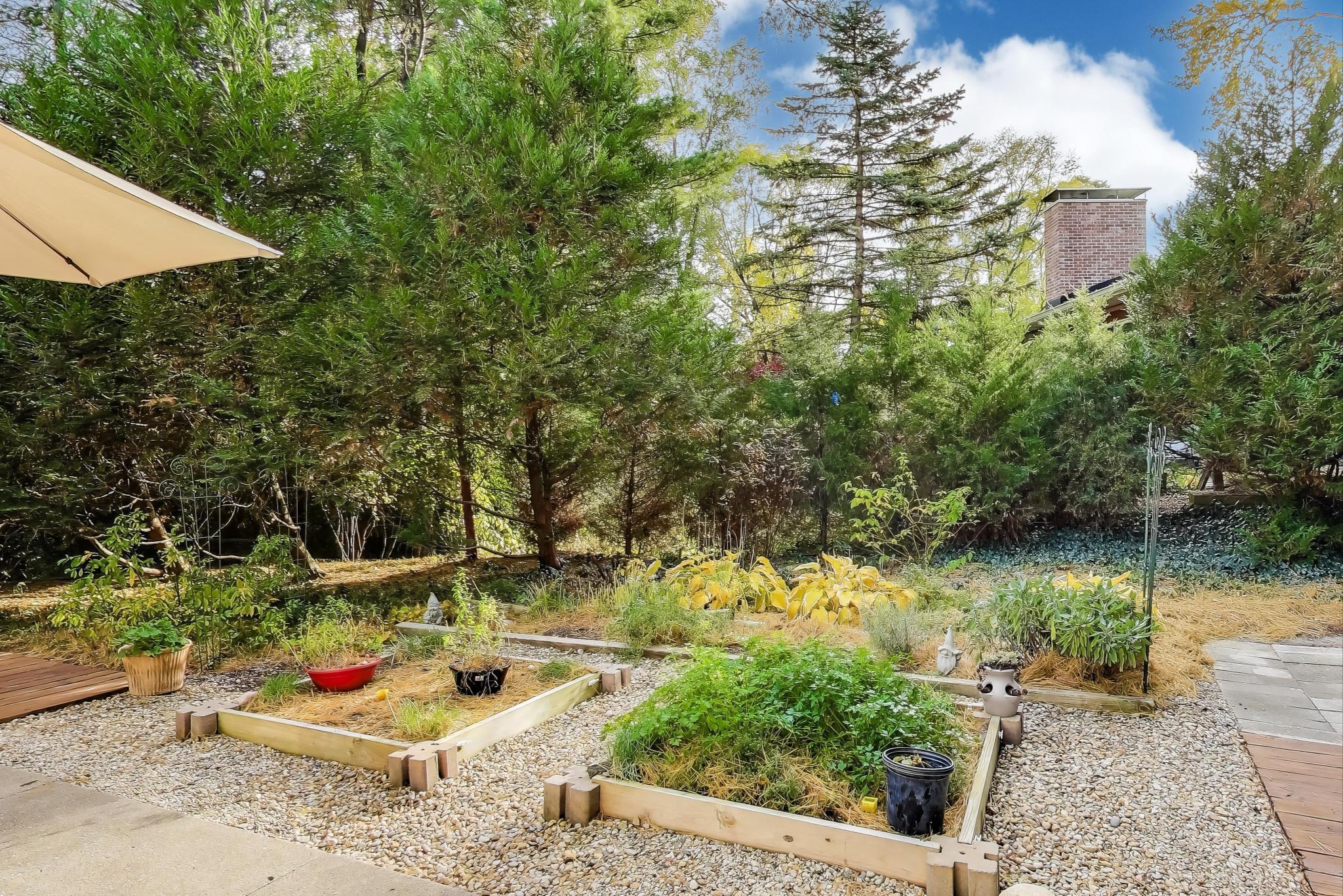 49 Aspen Road Ogden Dunes, IN 46368 - Photo 39 of 42 a backyard of a house with barbeque oven