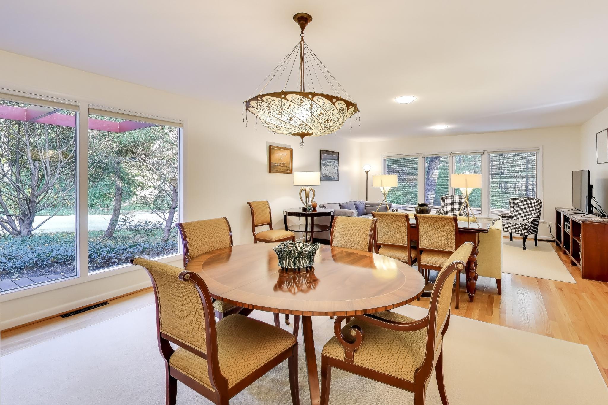 49 Aspen Road Ogden Dunes, IN 46368 - Photo 7 of 42 a view of a dining room with furniture wooden floor and a chandelier