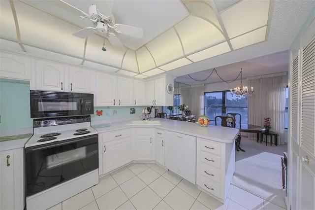 a kitchen with appliances a sink and cabinets