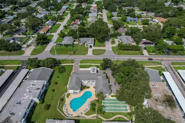 an aerial view of a house with a garden and lake view