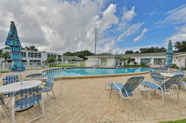 a view of swimming pool with outdoor seating and city view