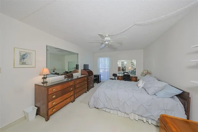 a bed room with bed and mirror